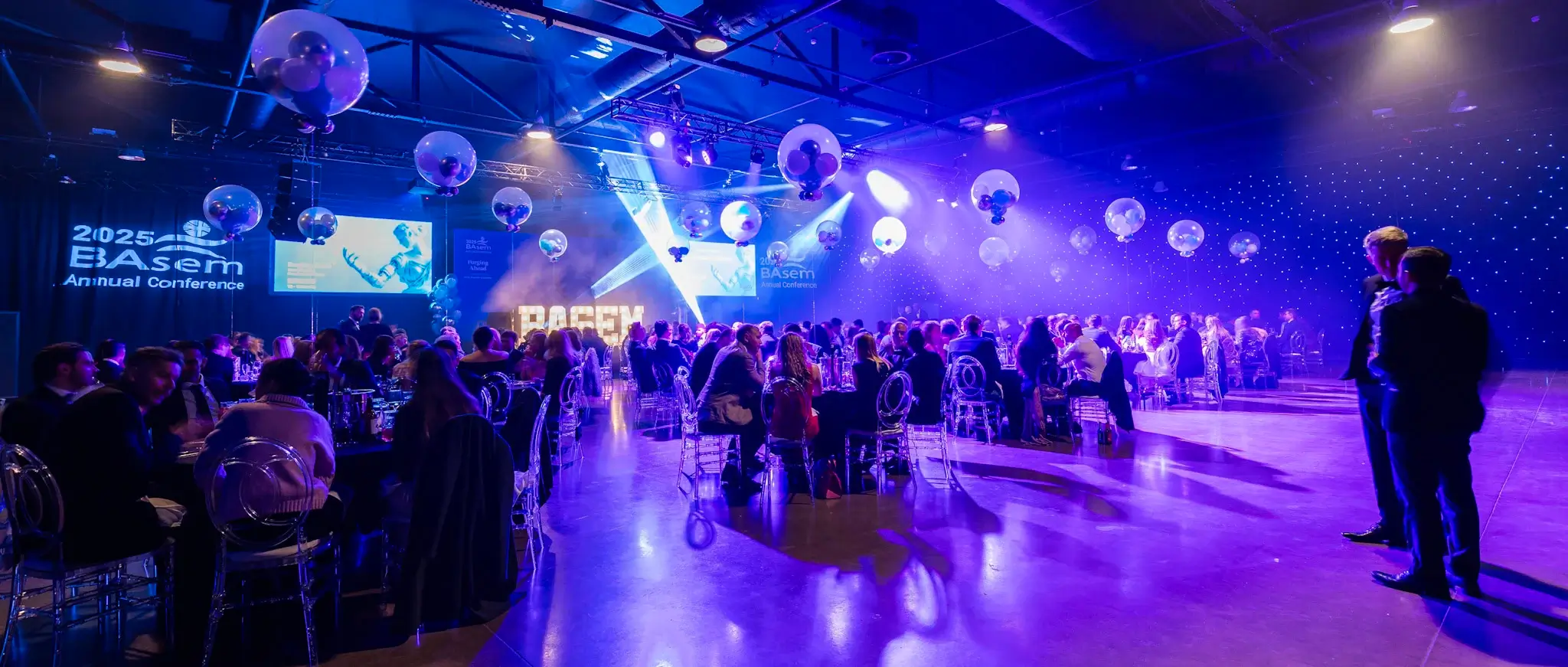 Guests enjoying the conference dinner with colourful lighting